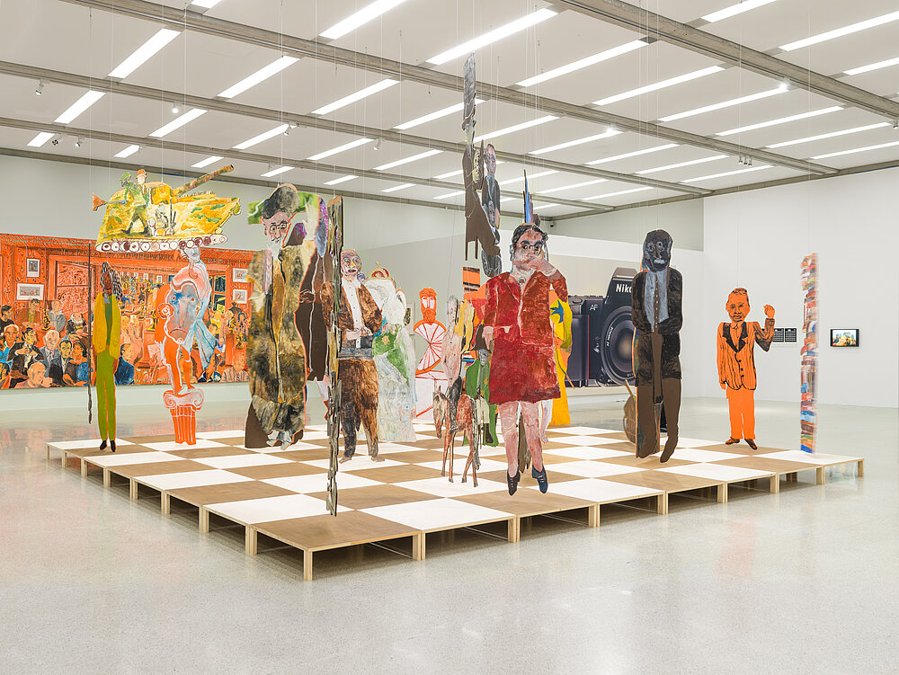 Artistic installation in the form of a chessboard with colourful cardboard figures on it