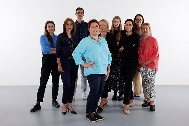 
            
                a group of people in front of a white wall, the exhibition management team at mumok
            
        
