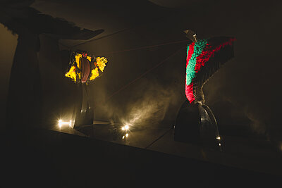 Two mixed media performing sculptures enact a computer controlled 6 minute drama which includes movement, song, the transformation of sound to light, and a laser display